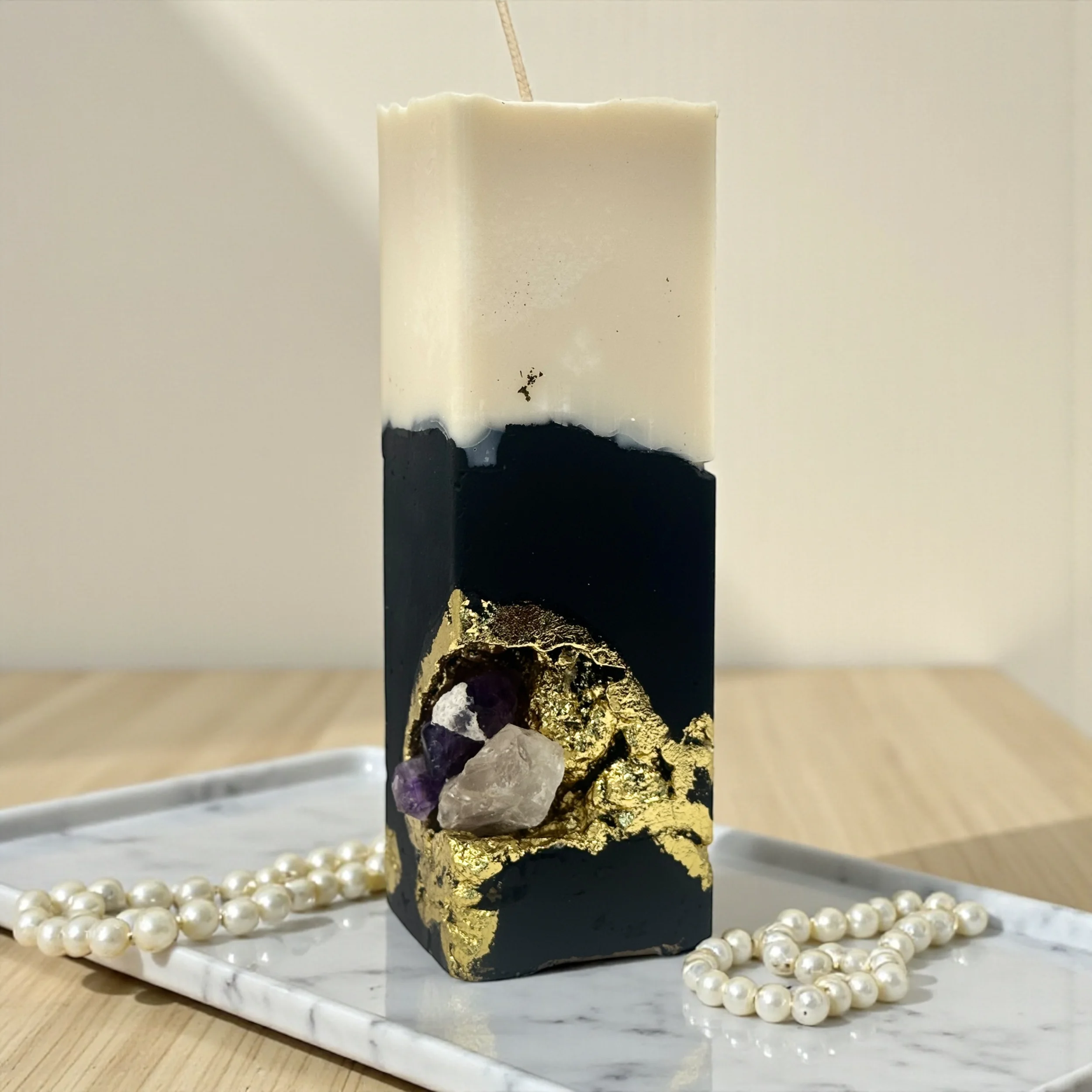 Handmade dark crystal geode candle created with black cement, gold leaf details and natural crystals. A sculptural luxury soy candle designed to bring depth, mystery and sensual energy into any space.