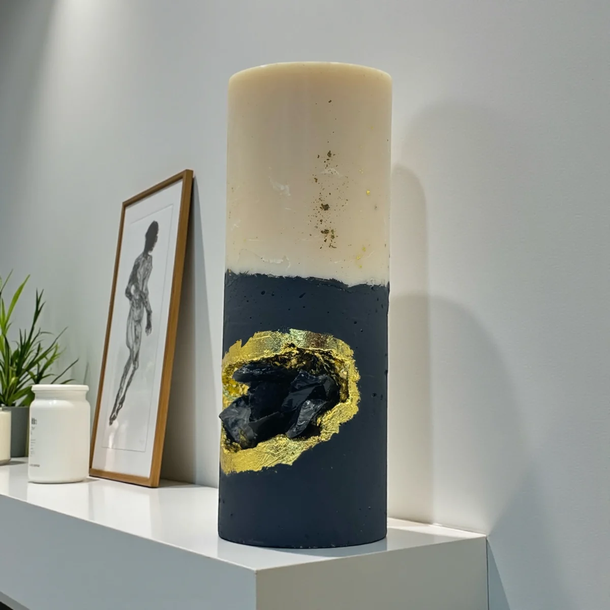 Midnight Ritual luxury handmade soy wax candle with black and ivory layers, gold leaf accents and a natural obsidian crystal, dark statement décor.