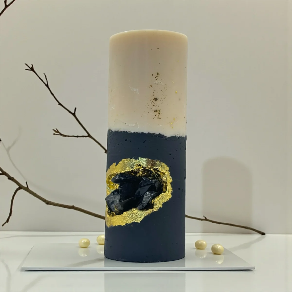 Midnight Ritual luxury handmade soy wax candle with black and ivory layers, gold leaf accents and a natural obsidian crystal, dark statement décor.