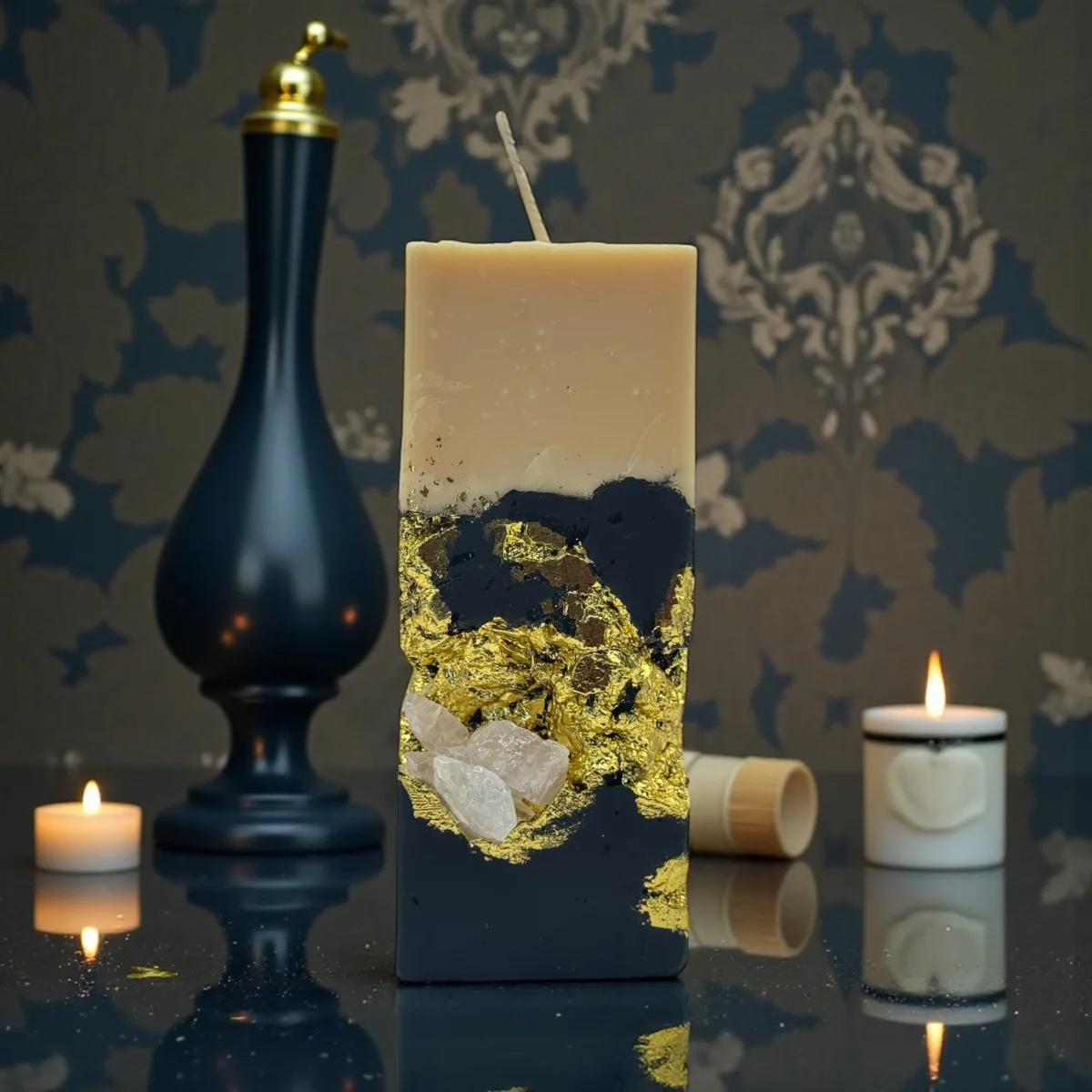 Smoky Seduction luxury handmade soy wax candle with black and ivory layers, gold leaf accents and a natural rose quartz crystal, elegant statement décor.