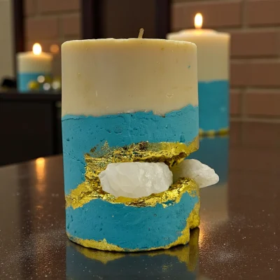 Ritual of Touch luxury handmade soy wax candle with black and ivory layers, gold leaf accents and a natural white aragonite crystal, elegant ritual décor.